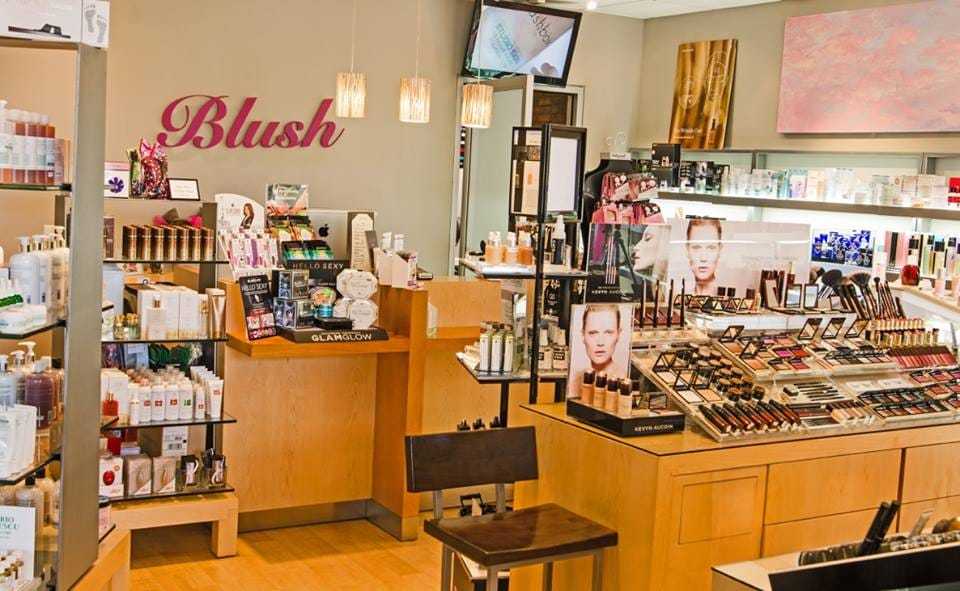 Makeup and skincare store interior with product displays and wooden furniture.