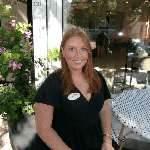 Portrait of Casey, a professional stylist at Elan Hair Studio, showcasing their expertise and style.